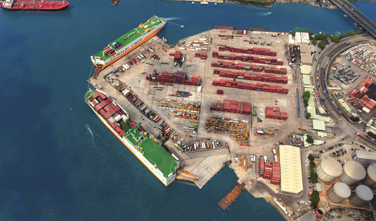 Aerial view of the PTML terminal with break bulk and project cargo alongside Grimaldi vessels